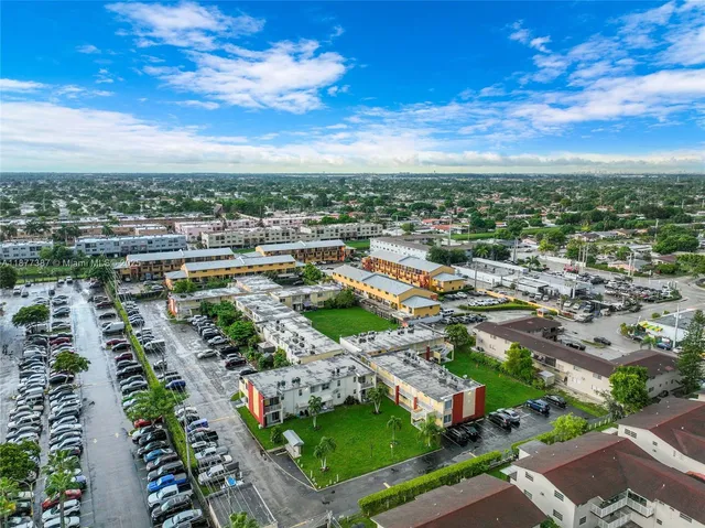 an aerial view of residential houses with outdoor space
