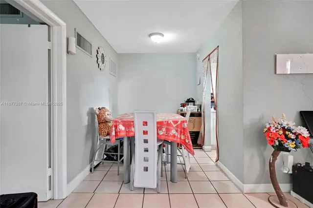 a living room with furniture and a baby crib