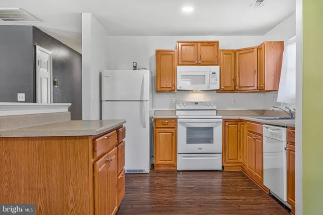 a kitchen with a refrigerator and a stove top oven