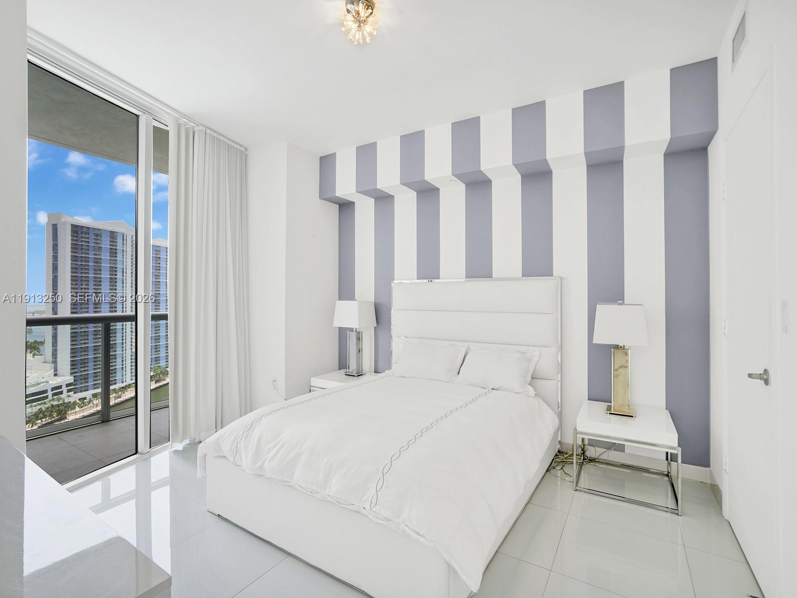 495 Brickell Avenue, Unit 2504 Miami, FL 33131 - Photo 14 of 28 a bedroom with a large bed and a window
