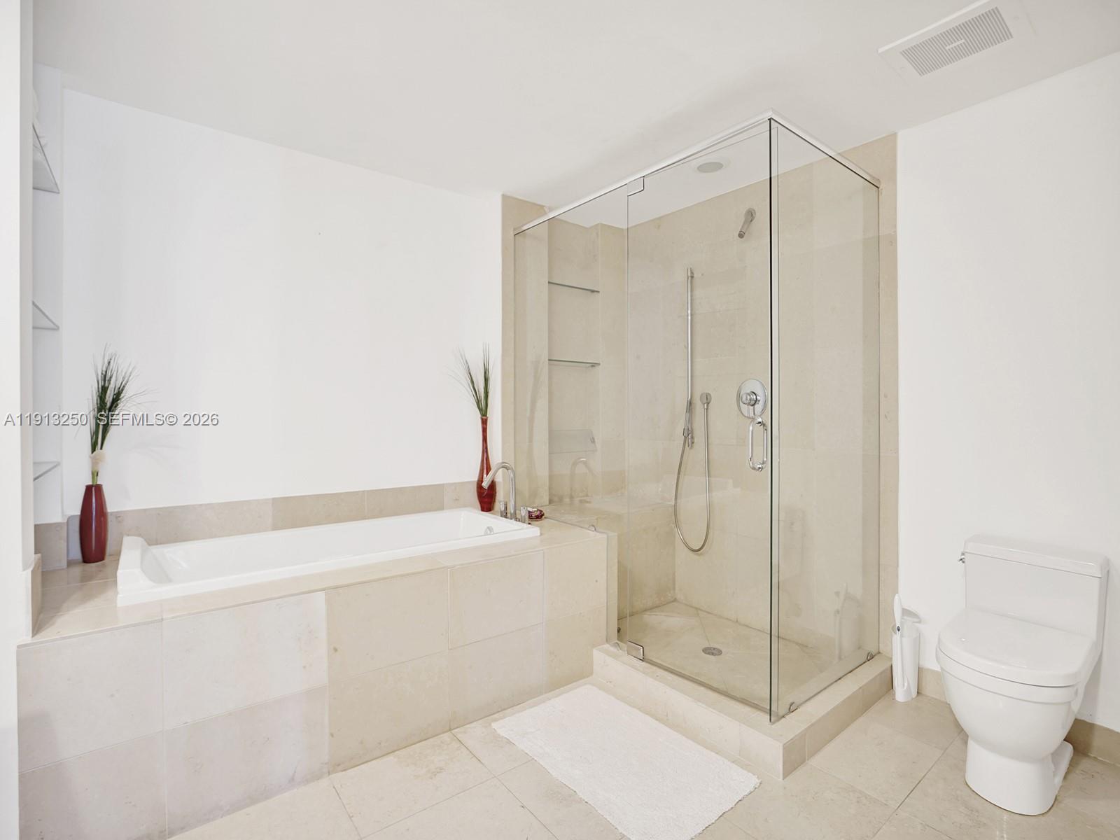 495 Brickell Avenue, Unit 2504 Miami, FL 33131 - Photo 17 of 28 a bathroom with a shower a toilet and a shower