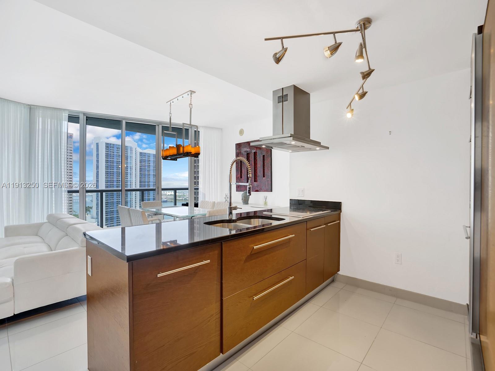 495 Brickell Avenue, Unit 2504 Miami, FL 33131 - Photo 6 of 28 a kitchen with stainless steel appliances granite countertop a sink and a refrigerator
