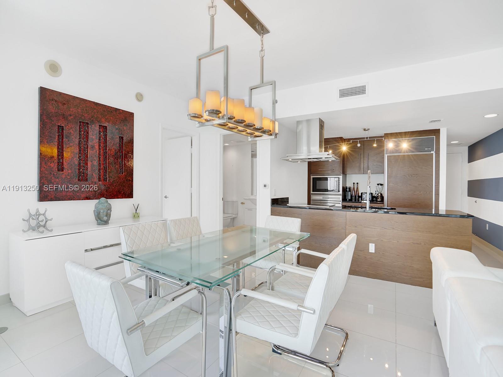 495 Brickell Avenue, Unit 2504 Miami, FL 33131 - Photo 9 of 28 a view of a dining room kitchen and a chandelier