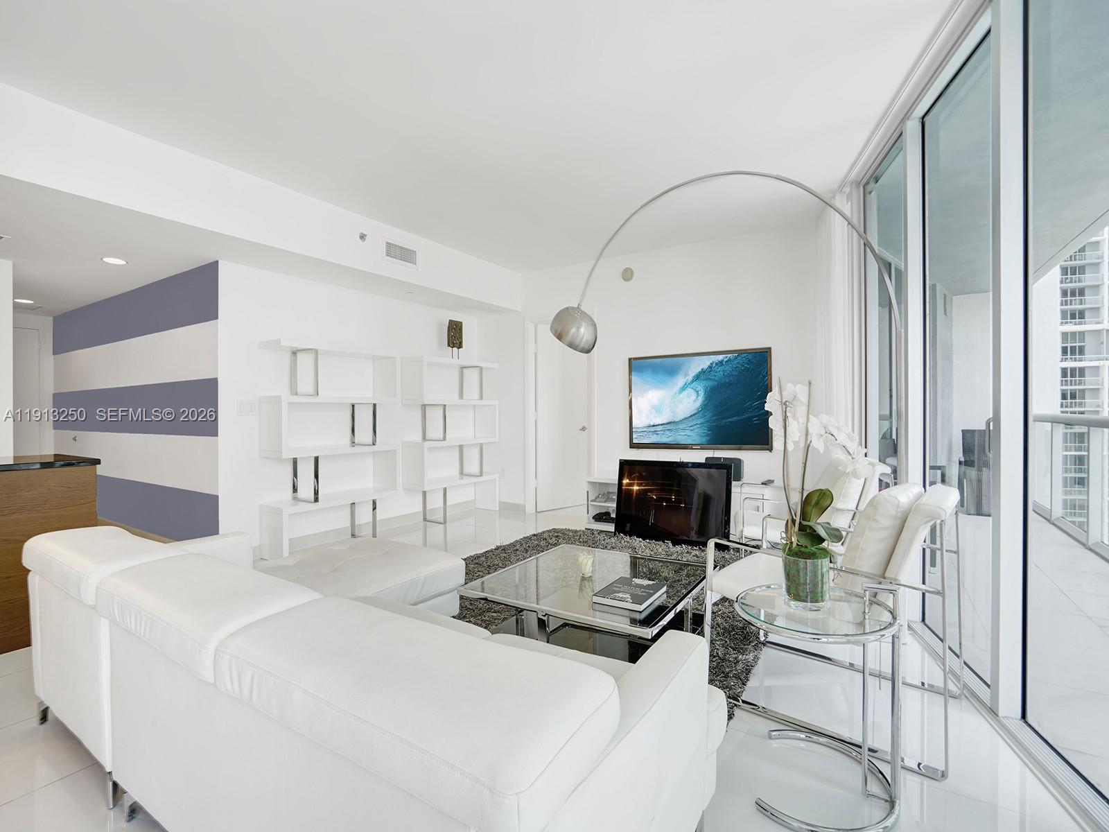 495 Brickell Avenue, Unit 2504 Miami, FL 33131 - Photo 10 of 28 a living room with furniture and a flat screen tv