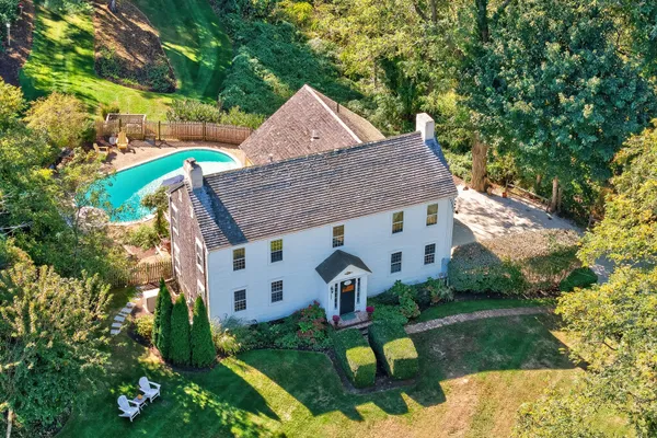 an aerial view of a house with a yard