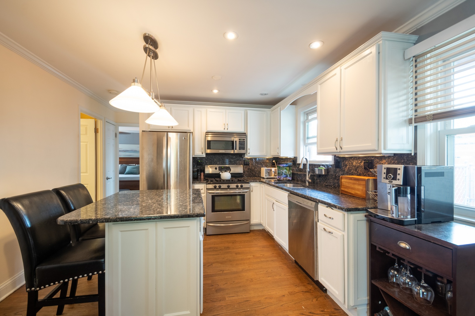 1315 Elliott Street Park Ridge, IL 60068 - Photo 5 of 10 a kitchen with stainless steel appliances granite countertop a stove top oven a sink dishwasher a refrigerator and white cabinets with wooden floor