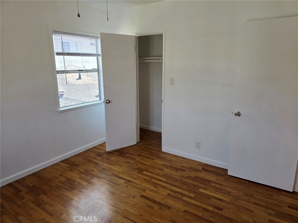 12503 Grevillea Avenue, Unit C Hawthorne, CA 90250 - Photo 12 of 13 an empty room with wooden floor and windows