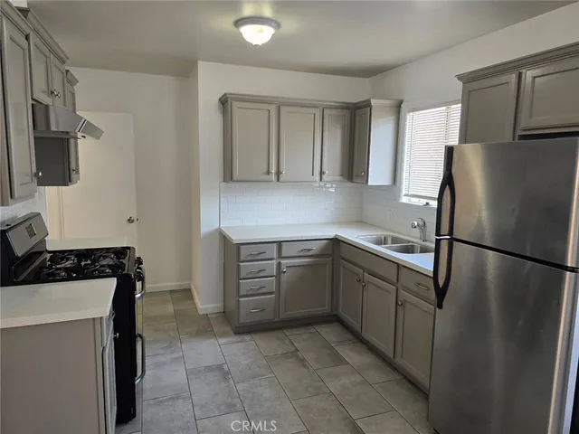 a kitchen with a refrigerator sink and stove