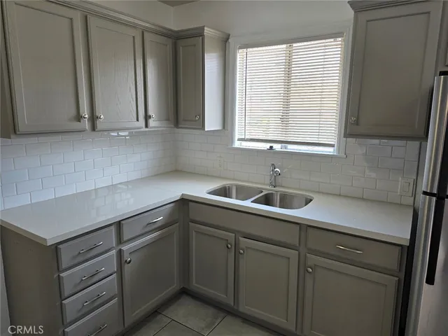 a kitchen with a sink and cabinets