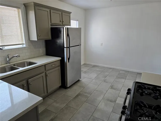 a kitchen with stainless steel appliances a refrigerator and a sink