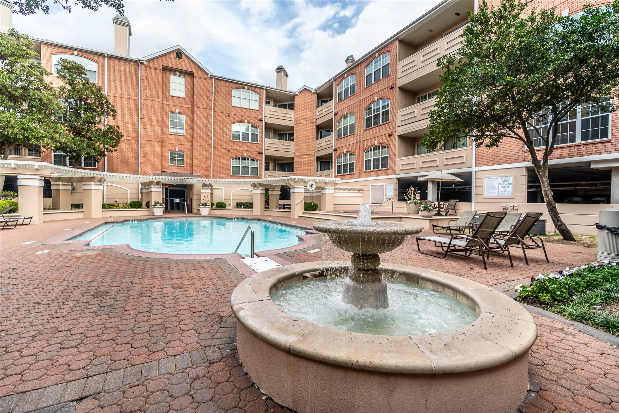 2111 Welch Street, Unit A232 Houston, TX 77019 - Photo 19 of 20 a view of a swimming pool with outdoor seating