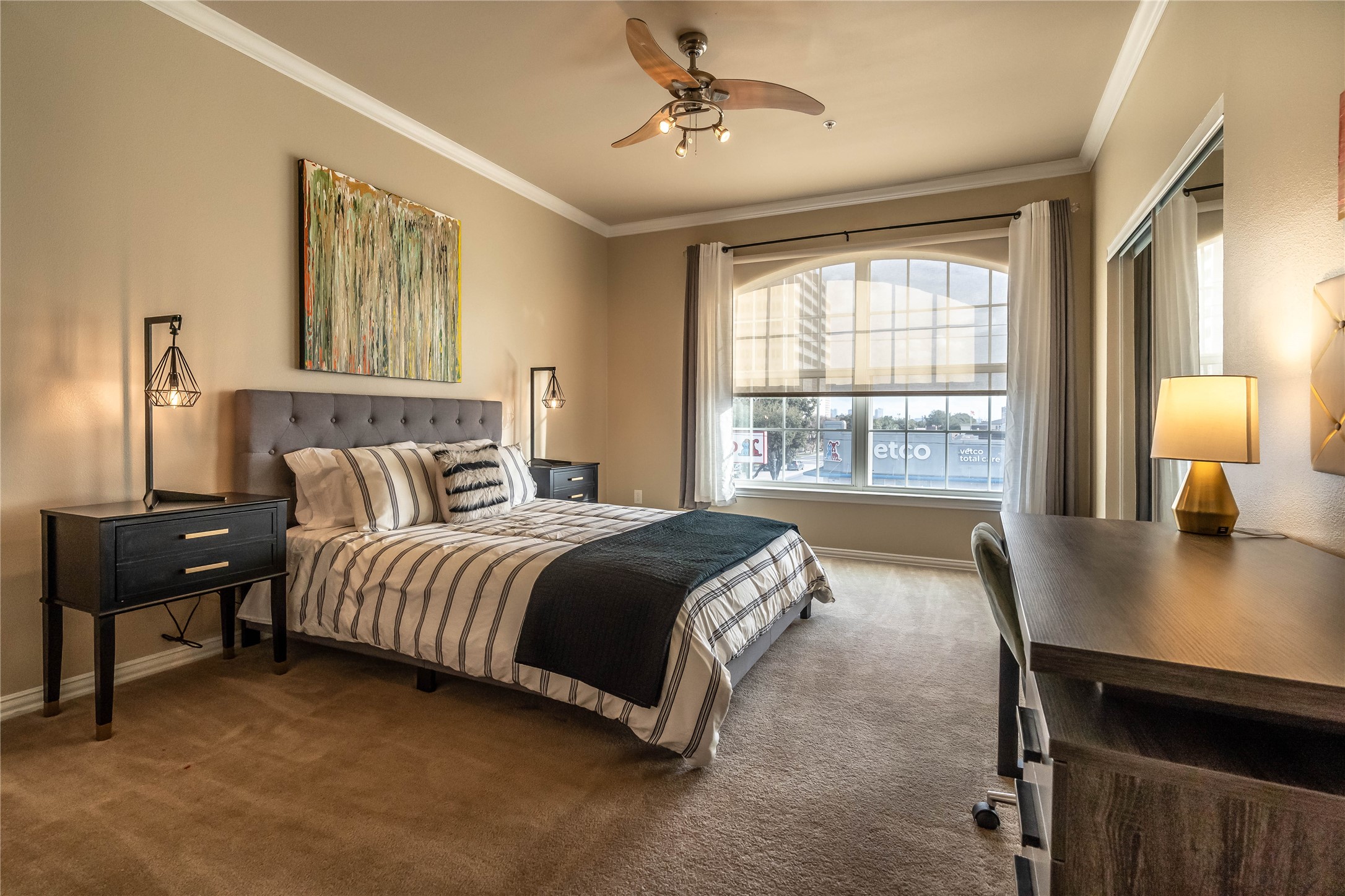 2111 Welch Street, Unit A232 Houston, TX 77019 - Photo 9 of 20 a spacious bedroom with a bed and a table in it