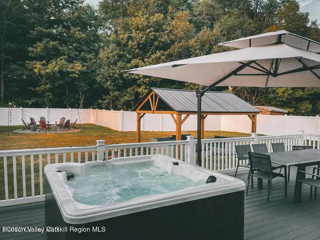 a view of a patio with a table and chairs under an umbrella