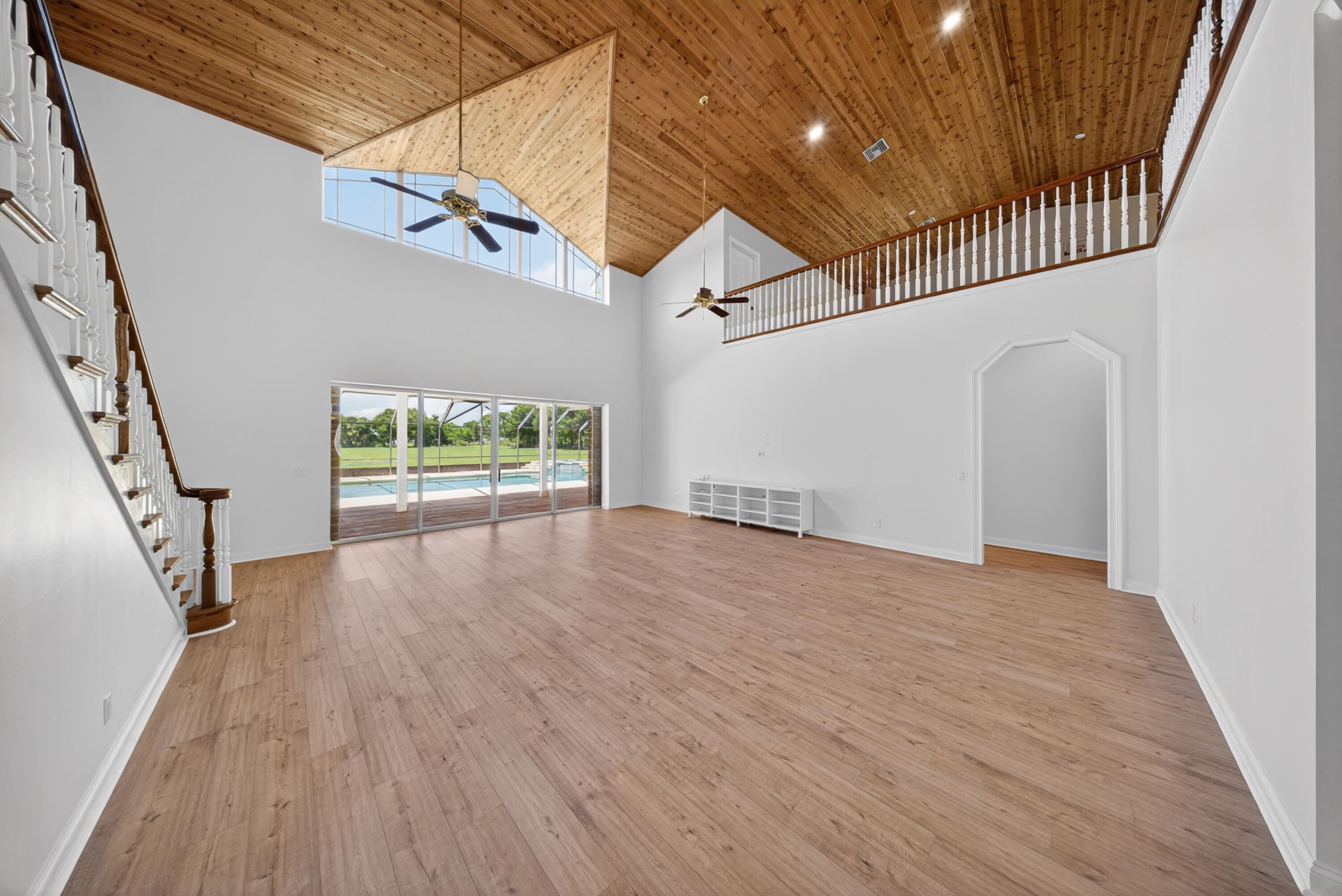 8686 Andrews Avenue Fort Pierce, FL 34945 - Photo 16 of 76 a view of hallway with wooden floor and stairs