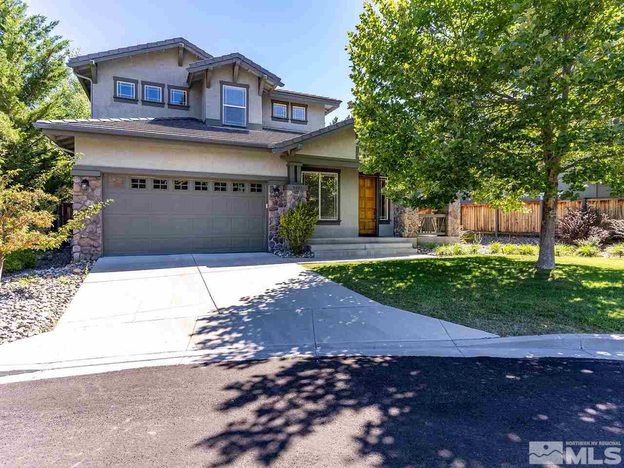 5021 Fall Colors Court Reno, NV 89519 - Photo 1 of 26 a front view of a house with a yard and a garage