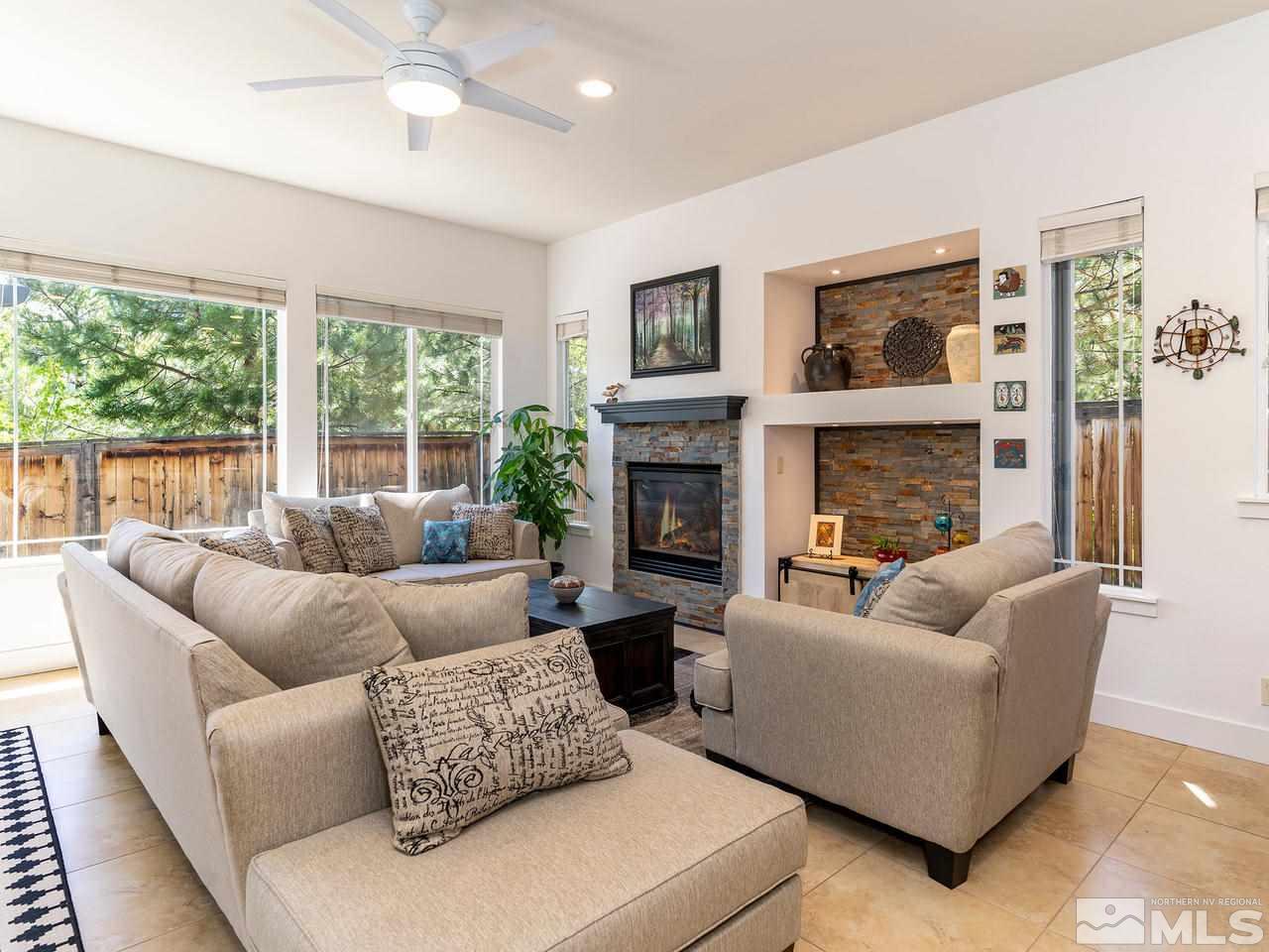 5021 Fall Colors Court Reno, NV 89519 - Photo 12 of 26 a living room with furniture a large window and a fireplace