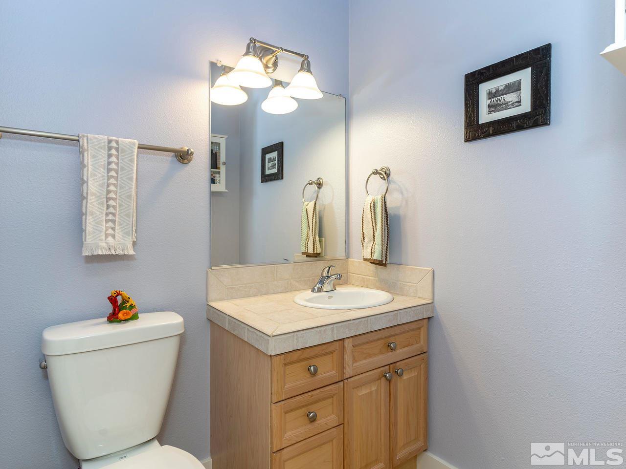 5021 Fall Colors Court Reno, NV 89519 - Photo 13 of 26 a bathroom with a toilet sink and mirror