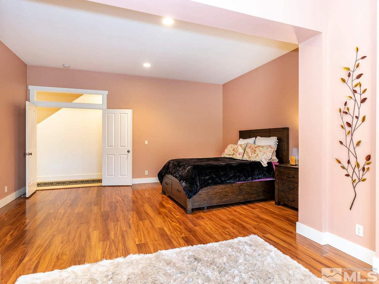 5021 Fall Colors Court Reno, NV 89519 - Photo 14 of 26 a bedroom with a bed and a walk in closet