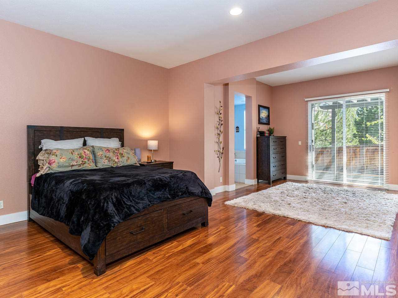 5021 Fall Colors Court Reno, NV 89519 - Photo 15 of 26 a bedroom with a bed and wooden floor
