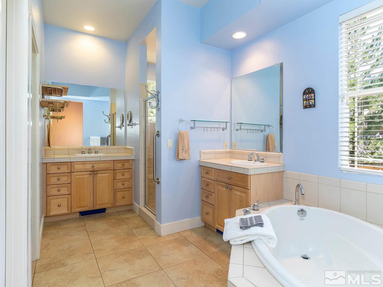 5021 Fall Colors Court Reno, NV 89519 - Photo 16 of 26 a bathroom with a sink a washer and dryer