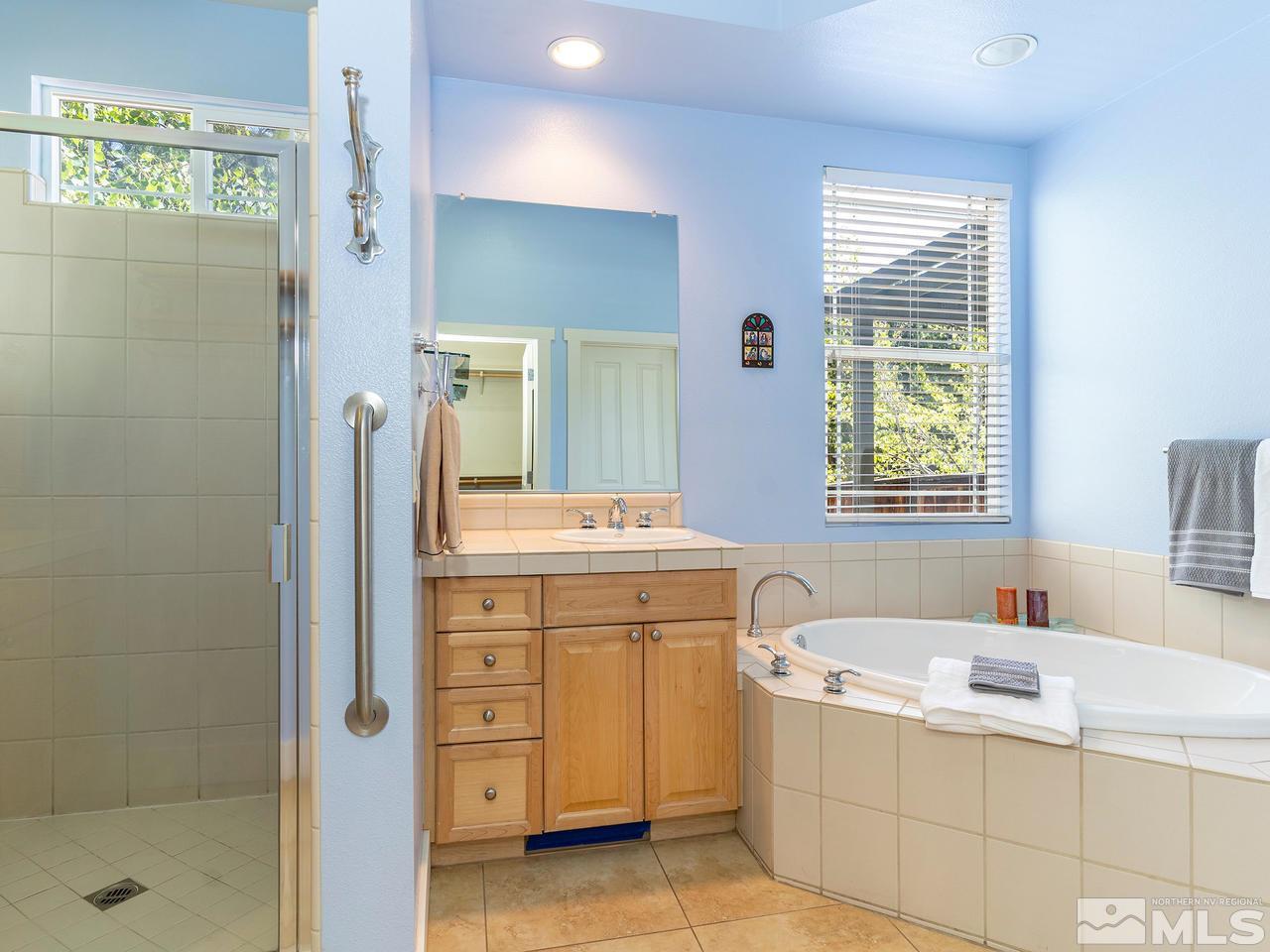 5021 Fall Colors Court Reno, NV 89519 - Photo 17 of 26 a bathroom with a tub sink and mirror