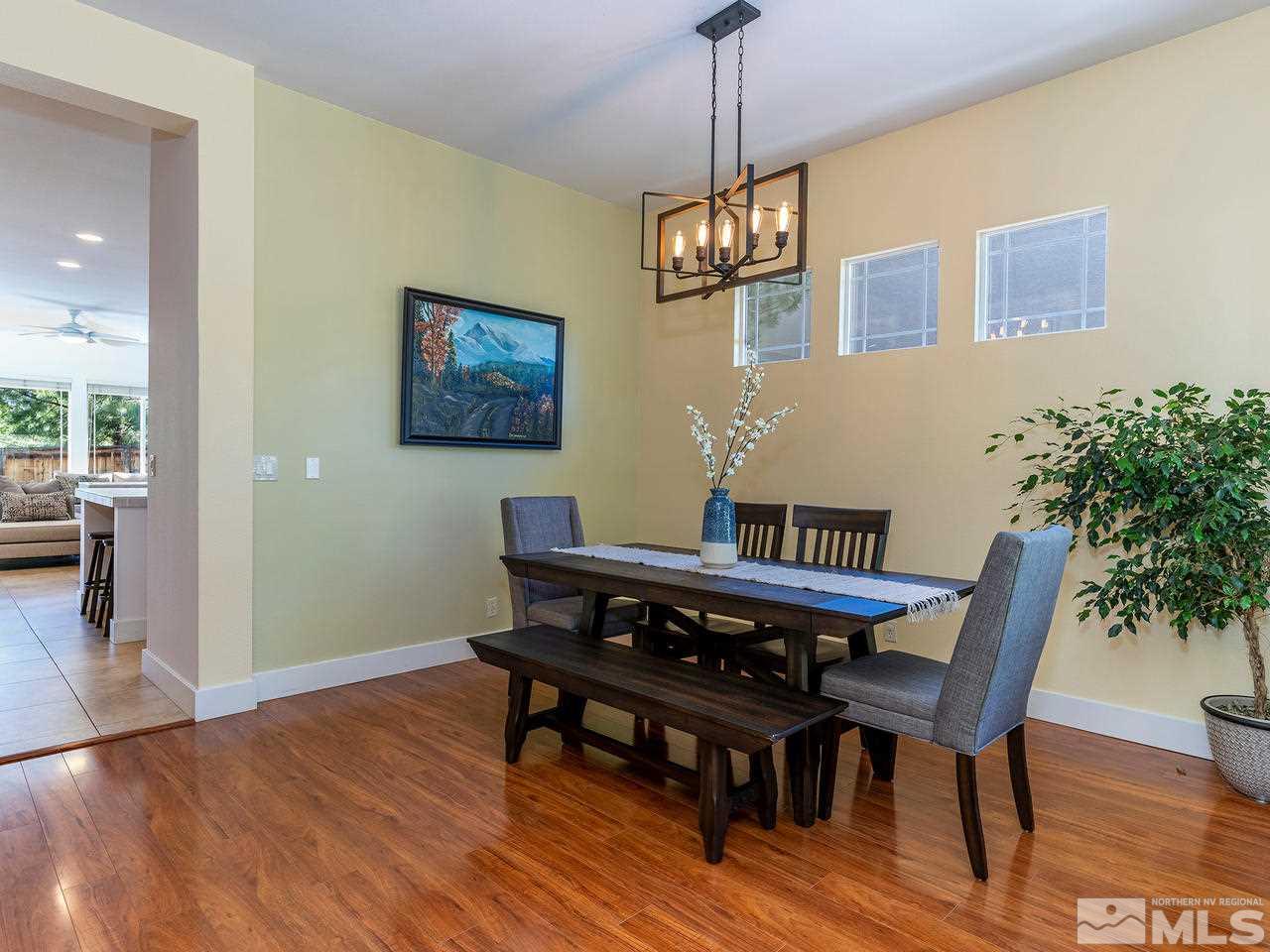 5021 Fall Colors Court Reno, NV 89519 - Photo 3 of 26 a view of a dining room with furniture wooden floor and a chandelier