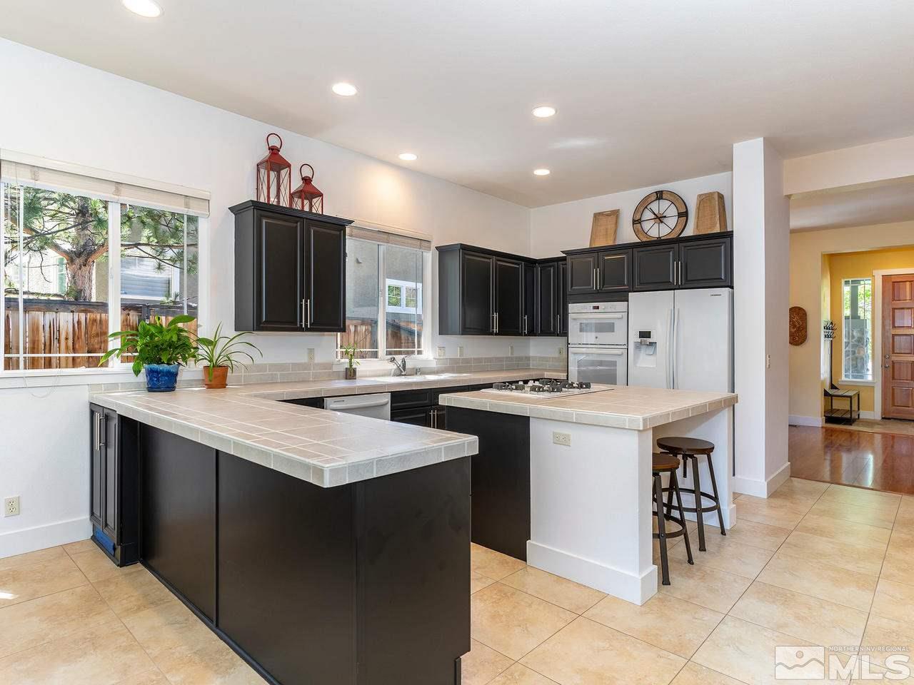 5021 Fall Colors Court Reno, NV 89519 - Photo 5 of 26 a kitchen with a sink a stove a refrigerator and a oven