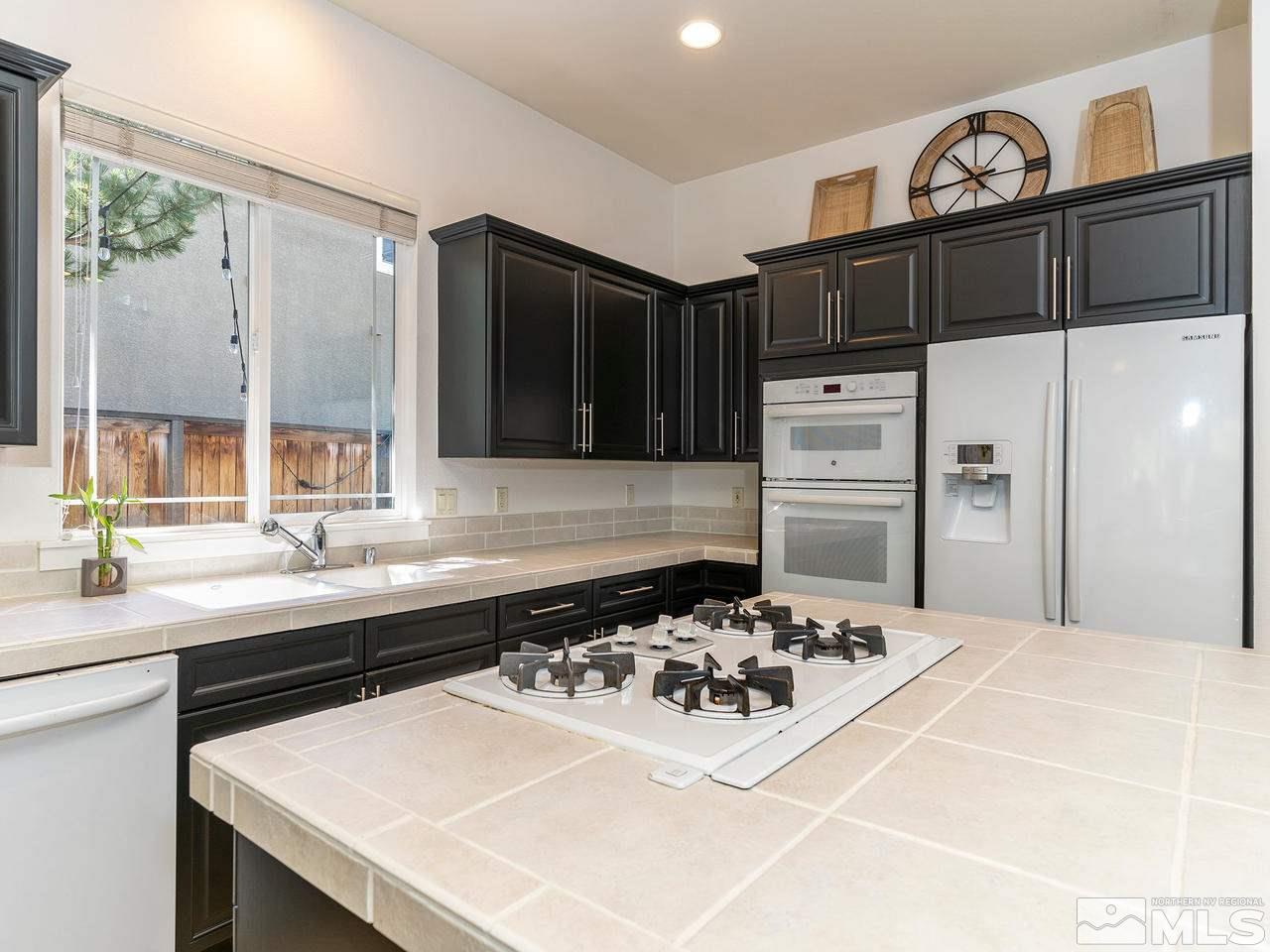 5021 Fall Colors Court Reno, NV 89519 - Photo 6 of 26 a kitchen with a sink a stove and refrigerator