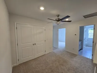 an empty room with a ceiling fan and a ceiling fan
