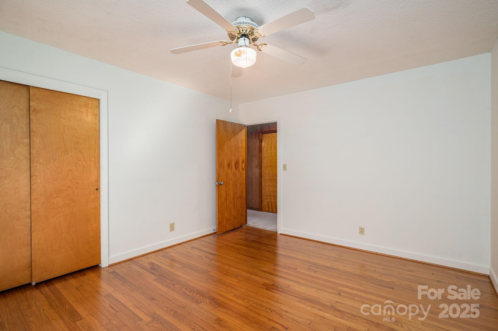 215 Suncrest Road Cherryville, NC 28021 - Photo 13 of 26 an empty room with wooden floor and fan