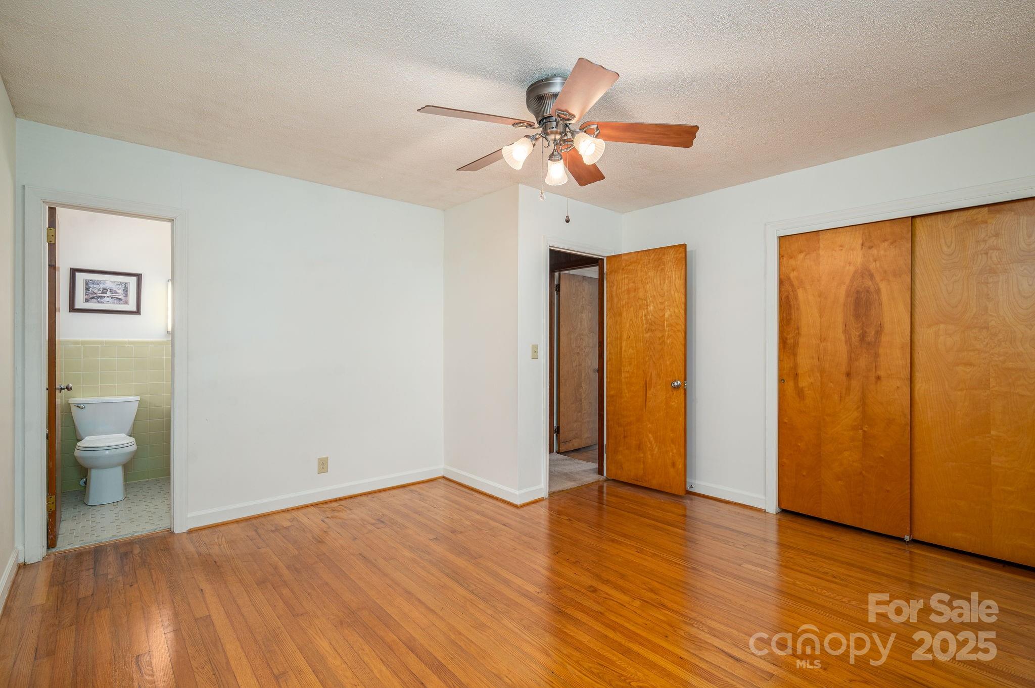 215 Suncrest Road Cherryville, NC 28021 - Photo 4 of 26 a view of a room with wooden floor and a ceiling fan
