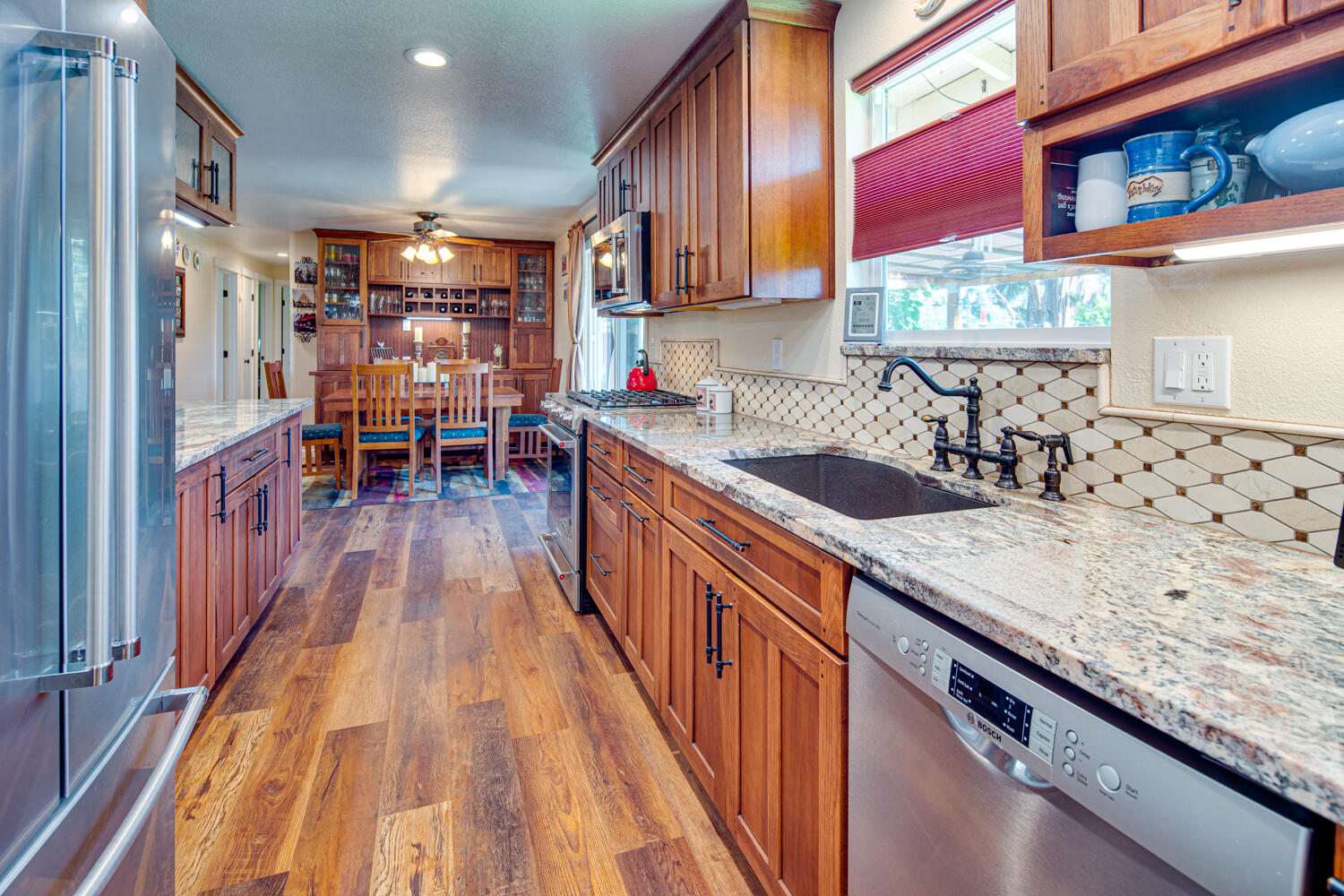 2218 Southwest 79th Street Redmond, OR 97756 - Photo 8 of 54 a kitchen with granite countertop lots of counter top space and wooden floor