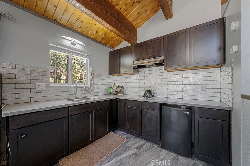 33080 Robin Lane Running Springs, CA 92382 - Photo 14 of 35 a kitchen with stainless steel appliances wooden cabinets a sink and a stove