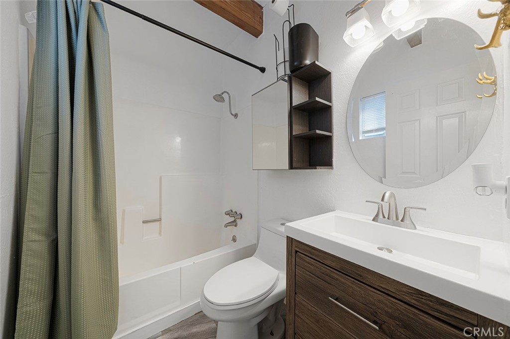 33080 Robin Lane Running Springs, CA 92382 - Photo 25 of 35 a bathroom with a sink a toilet a mirror and shower