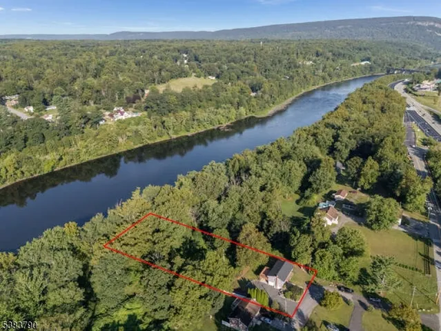 an aerial view of lake and residential houses with outdoor space