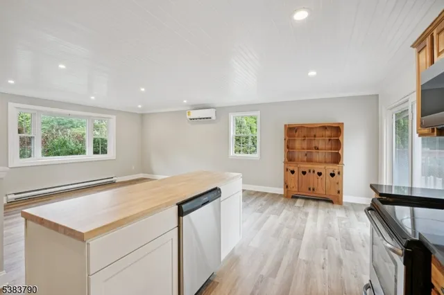 a kitchen with wooden cabinets and a wooden floor