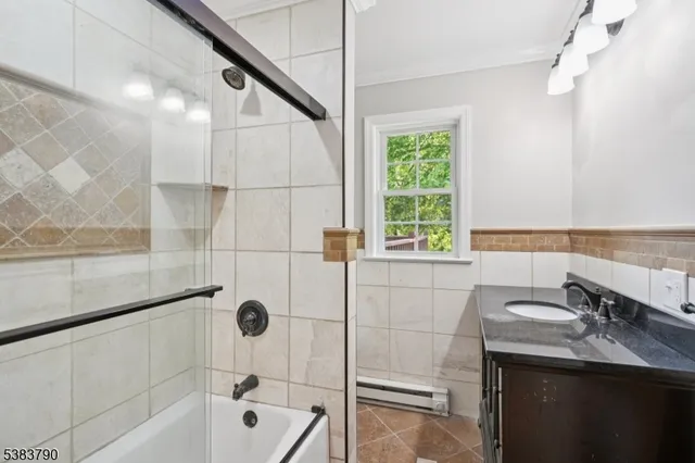 a bathroom with a tub sink and mirror