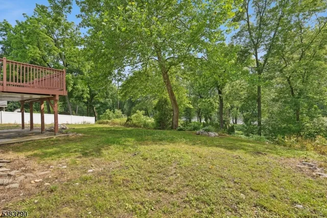 a view of a yard with a house in the background