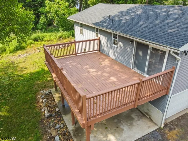 a balcony with wooden floor and fence