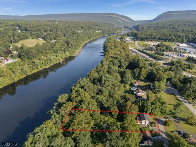 an aerial view of residential house with outdoor space and trees