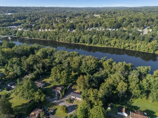 an aerial view of a houses with a yard