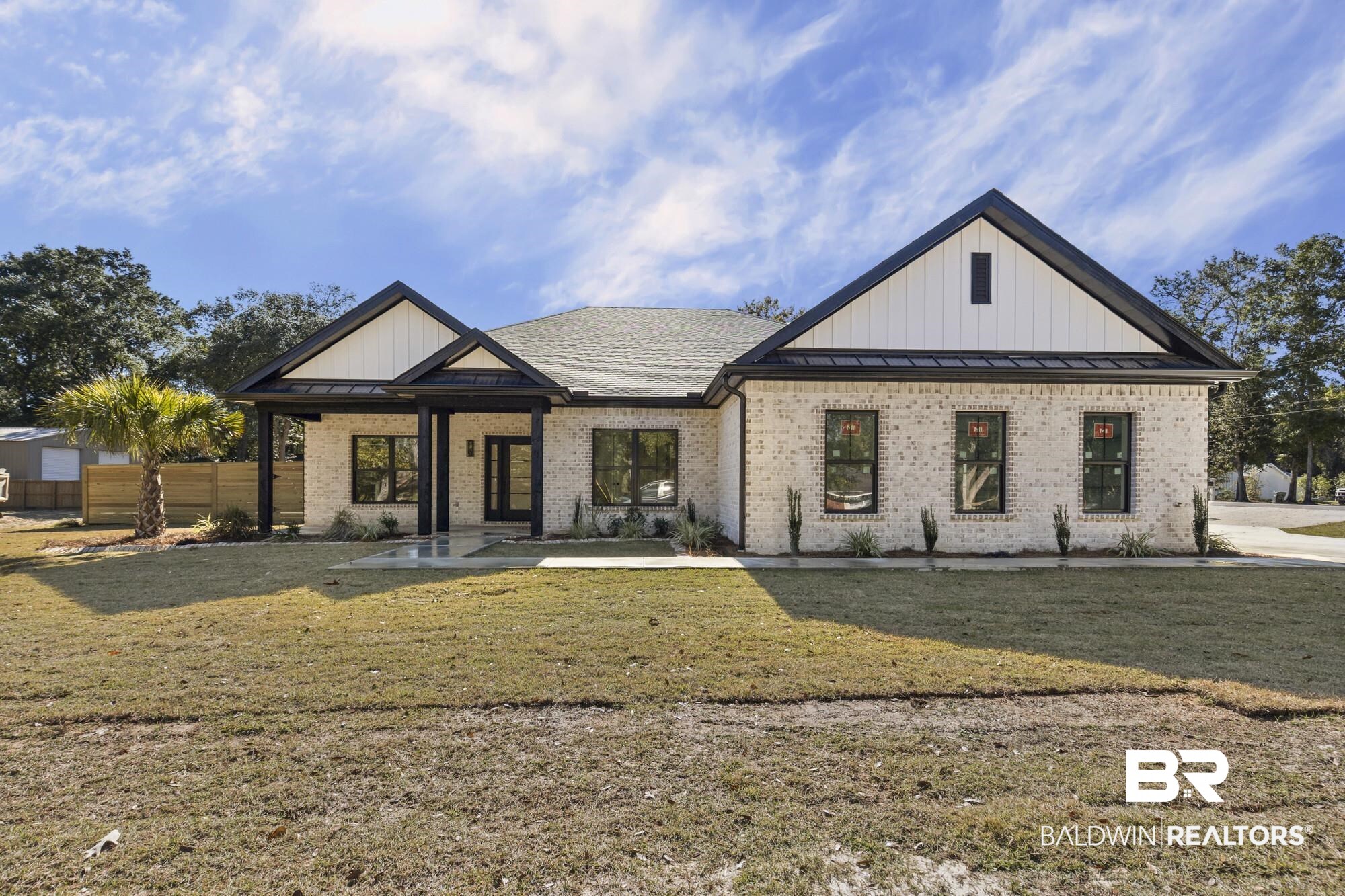 10180 Pineview Drive Foley, AL 36535 - Photo 1 of 47 Modern farmhouse with a standing seam roof, a metal roof, brick siding, and board and batten siding