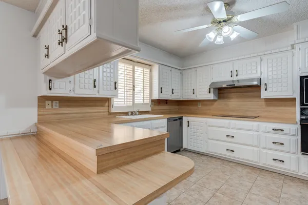 a bathroom with a granite countertop sink a toilet and a shower