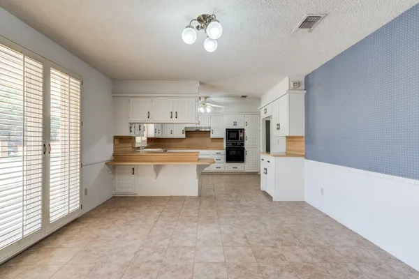 a bathroom with a granite countertop sink and a large mirror
