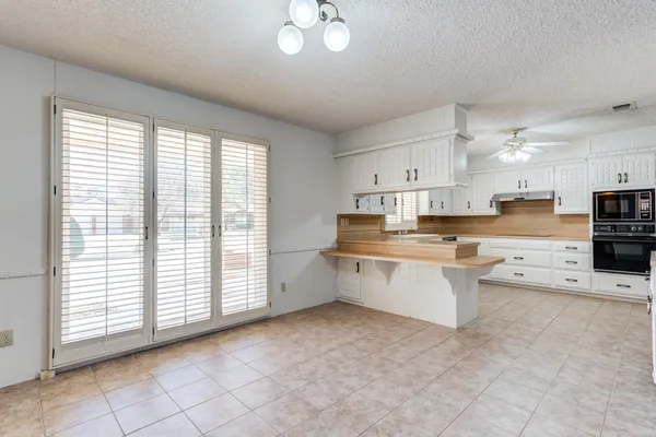 a view of a livingroom with a ceiling fan and window