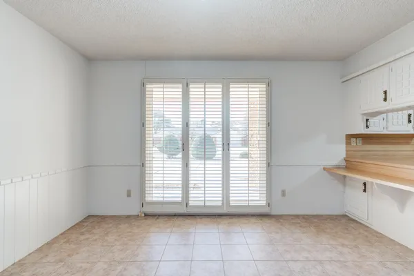 a bathroom with a double vanity sink a large mirror and a bathtub