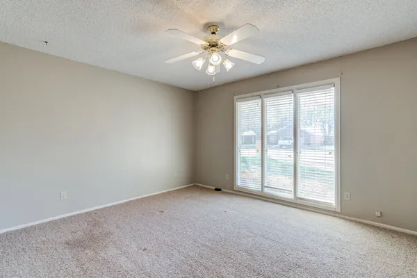a view of a house with backyard and a tree