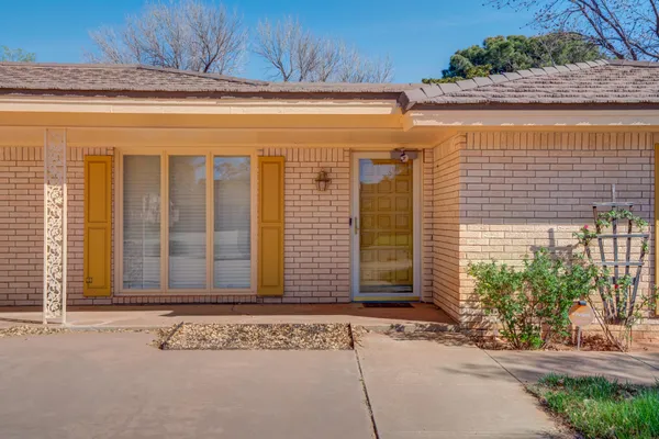an empty room with a ceiling fan and window
