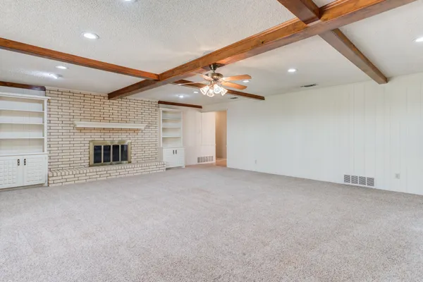 a kitchen with granite countertop white cabinets and stainless steel appliances