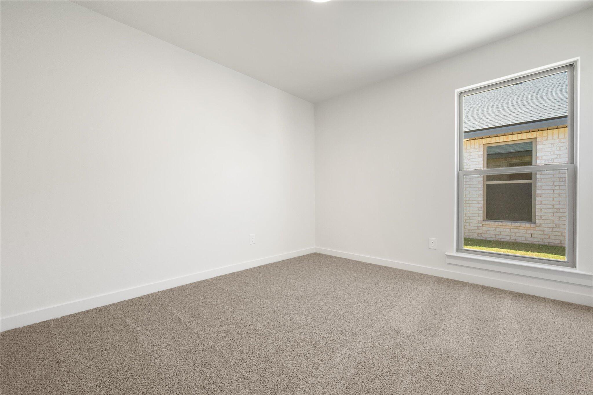 7214 8th Street Lubbock, TX 79416 - Photo 18 of 23 an empty room with a window